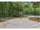 Community basketball court next to the tennis court and surrounded by woods at 4062 Vinings Mill Se Trl, Smyrna, GA 30080