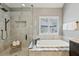 A modern bathroom features a soaking tub and a walk-in shower with elegant marble-look tile at 4062 Vinings Mill Se Trl, Smyrna, GA 30080