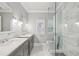 Bright, neutral bathroom featuring dual sinks, marble countertops, a glass shower, and modern fixtures at 4062 Vinings Mill Se Trl, Smyrna, GA 30080
