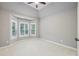 Well-lit bedroom with a bay window featuring plantation shutters and neutral carpeting at 4062 Vinings Mill Se Trl, Smyrna, GA 30080