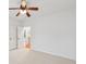 Bright bedroom features a ceiling fan, neutral carpet, and a door leading to a hallway at 4062 Vinings Mill Se Trl, Smyrna, GA 30080