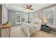Comfortable bedroom with neutral walls, plantation shutters, ceiling fan, and soft carpeting at 4062 Vinings Mill Se Trl, Smyrna, GA 30080