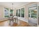 Breakfast nook with hardwood floors opens to outdoor seating on screened porch at 4062 Vinings Mill Se Trl, Smyrna, GA 30080