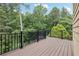 Wooden deck overlooks a lush green yard with trees and provides outdoor space at 4062 Vinings Mill Se Trl, Smyrna, GA 30080