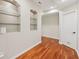 Hallway features hardwood floors, built-in shelves, and a door leading to another room at 4062 Vinings Mill Se Trl, Smyrna, GA 30080