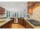 Modern kitchen with stainless steel appliances, granite countertops and dark wood cabinets at 4062 Vinings Mill Se Trl, Smyrna, GA 30080