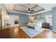 Beautiful main bedroom with a tray ceiling, ceiling fan, hardwood floors, and access to the ensuite at 4062 Vinings Mill Se Trl, Smyrna, GA 30080