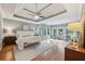 Spacious main bedroom boasts a tray ceiling, ceiling fan, ample natural light, and a seating area at 4062 Vinings Mill Se Trl, Smyrna, GA 30080