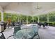 Outdoor patio area with seating, tables, ceiling fans, and lush greenery views at 4062 Vinings Mill Se Trl, Smyrna, GA 30080