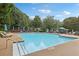 Large community pool with lounge chairs and umbrellas surrounded by trees at 4062 Vinings Mill Se Trl, Smyrna, GA 30080