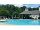 Relaxing pool with a covered area that offers shaded seating and a perfect view of the lush greenery at 4062 Vinings Mill Se Trl, Smyrna, GA 30080