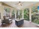 Cozy screened porch with comfortable seating and scenic views of wooded backyard at 4062 Vinings Mill Se Trl, Smyrna, GA 30080
