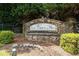 Stone community sign that marks the entrance to Olde Vinings Mill surrounded by green shrubs at 4062 Vinings Mill Se Trl, Smyrna, GA 30080