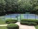 Well-maintained tennis court with surrounding trees and landscaping at 4062 Vinings Mill Se Trl, Smyrna, GA 30080