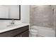 Stylish bathroom with stone-like tiled shower, dark vanity with a white counter at 784 Keystone Dr, Woodstock, GA 30188