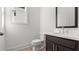 This half bath includes a vanity, toilet and window for natural light at 784 Keystone Dr, Woodstock, GA 30188