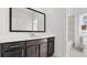 Modern bathroom features dark vanity with a black framed mirror and tiled shower at 784 Keystone Dr, Woodstock, GA 30188