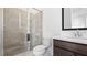 Bathroom featuring glass shower, white counter and dark cabinets at 784 Keystone Dr, Woodstock, GA 30188