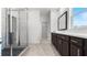 A bathroom features a glass enclosed shower, large vanity, and tiled floors at 784 Keystone Dr, Woodstock, GA 30188