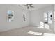 Bright bedroom featuring three large windows, ceiling fan and plush carpet at 784 Keystone Dr, Woodstock, GA 30188