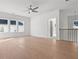 A spacious bonus room with hardwood floors, natural light, and staircase at 784 Keystone Dr, Woodstock, GA 30188