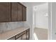 Butler's pantry with custom cabinets, countertops, and view into dining room at 784 Keystone Dr, Woodstock, GA 30188