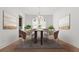 Formal dining room featuring modern chandelier, seating for six, and sophisticated decor and natural light at 784 Keystone Dr, Woodstock, GA 30188