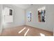 Bright, freshly painted empty room with hardwood floors and two windows, ready for a personal touch at 784 Keystone Dr, Woodstock, GA 30188