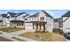 Two-story home boasting a welcoming front porch, a two-car garage, and lush landscaping in a desirable area at 784 Keystone Dr, Woodstock, GA 30188
