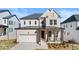Charming two-story home featuring a covered porch, two-car garage, and classic architectural details at 784 Keystone Dr, Woodstock, GA 30188