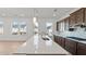 Large kitchen island with sink, stainless appliances, and pendant lighting at 784 Keystone Dr, Woodstock, GA 30188