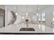 Modern kitchen island with sink overlooking spacious living area with fireplace and hardwood floors at 784 Keystone Dr, Woodstock, GA 30188