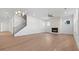 Bright living room with hardwood floors, fireplace, and staircase with iron railings at 784 Keystone Dr, Woodstock, GA 30188
