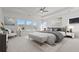 Bright and airy main bedroom with tray ceiling, large windows, neutral tones, and elegant furnishings at 784 Keystone Dr, Woodstock, GA 30188