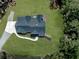 Aerial view of a home with a dark roof and well-manicured lawn at 1170 Upper Sweetwater Se Trl, White, GA 30184