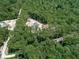 Aerial view of homes nestled within a dense, lush forest at 1170 Upper Sweetwater Se Trl, White, GA 30184