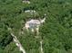 Aerial view of two new homes nestled in a lush green forest at 1170 Upper Sweetwater Se Trl, White, GA 30184