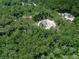 Aerial view of homes nestled within a dense, lush forest at 1170 Upper Sweetwater Se Trl, White, GA 30184