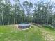 Above ground pool in a backyard surrounded by a lush forest and green grass at 1170 Upper Sweetwater Se Trl, White, GA 30184