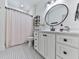 Stylish bathroom featuring a vanity with marble countertop, oval mirror, and mosaic tile floors at 1170 Upper Sweetwater Se Trl, White, GA 30184