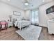 Cozy bedroom features a white metal bed frame, plush rug, and neutral color palette at 1170 Upper Sweetwater Se Trl, White, GA 30184