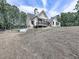 Beautiful exterior view of a modern farmhouse with a covered deck overlooking a large yard at 1170 Upper Sweetwater Se Trl, White, GA 30184