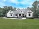 Inviting modern farmhouse with a welcoming front porch, well-manicured lawn, and stylish architectural details at 1170 Upper Sweetwater Se Trl, White, GA 30184