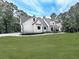 Elegant farmhouse featuring a manicured lawn, architectural design, and stylish features at 1170 Upper Sweetwater Se Trl, White, GA 30184