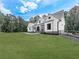 Charming farmhouse with a covered porch and a large green lawn creating a picturesque setting at 1170 Upper Sweetwater Se Trl, White, GA 30184