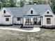 Charming front exterior of a modern farmhouse with rocking chairs at 1170 Upper Sweetwater Se Trl, White, GA 30184