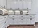 Detailed view of the kitchen cabinets with sleek hardware and countertops at 1170 Upper Sweetwater Se Trl, White, GA 30184
