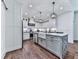 Bright kitchen with a farmhouse sink, stainless steel appliances, and modern pendant lighting at 1170 Upper Sweetwater Se Trl, White, GA 30184