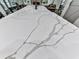 Close-up shot of a kitchen island with a luxurious marble countertop and ample space at 1170 Upper Sweetwater Se Trl, White, GA 30184