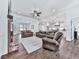 Open-concept living space showcases hardwood floors, fireplace, and kitchen beyond at 1170 Upper Sweetwater Se Trl, White, GA 30184